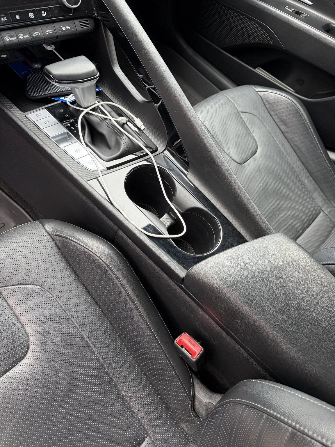 Clean Hyundai Elantra center console, cupholders, shifter, and surrounding trim