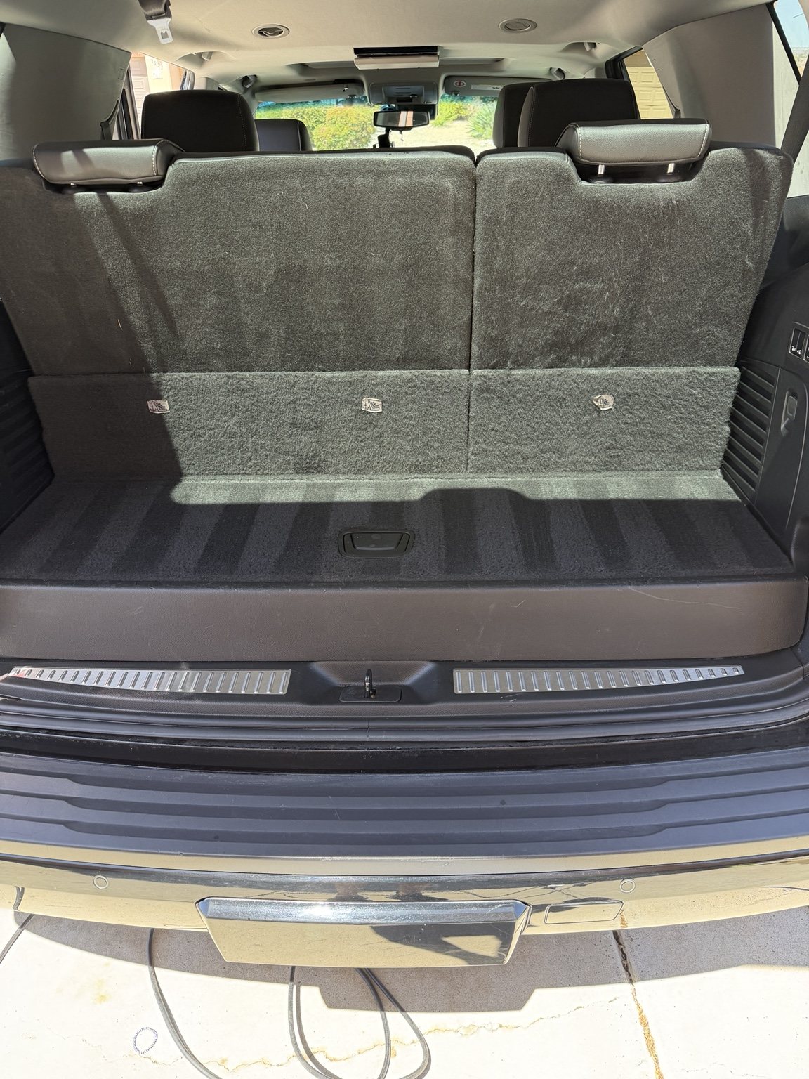 Clean Chevrolet Tahoe cargo area with restored carpet and surrounding trim